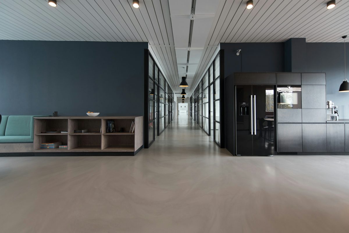 Open studio workspace with meeting rooms